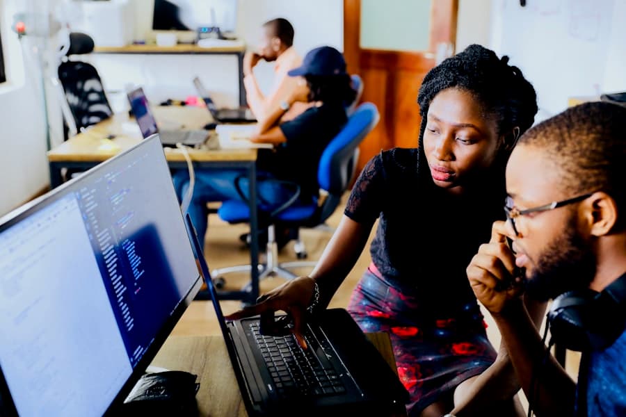 Learners working together at a laptop